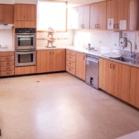 Large kitchen space with double wall ovens, dish washer and counter space.