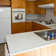 Kitchen with refrigerator, wall oven and food preparation areas..