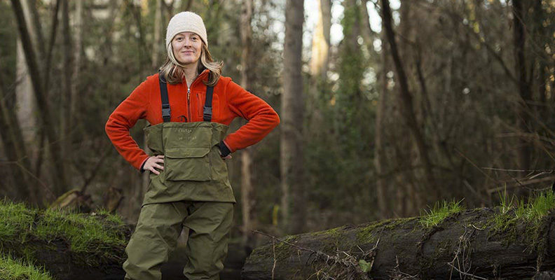 Dr. Jen McIntyer wearing waders in the forest.