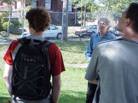 Dr. Chalker Scott talks to two students (backs to camera).