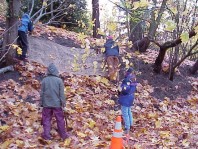 Cutting coir and placing it on the steep slope to control erosion.