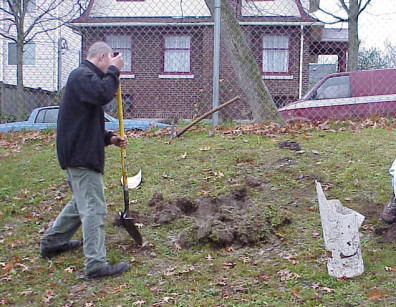 Digging planting holes with assistance from NOVA students.