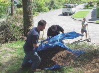 Running the mulch down the slope and dumping it in place.