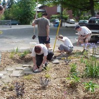 Installing pavers to create a path through the big bed
