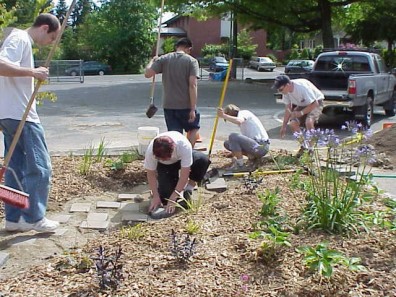 Installing pavers to create a path through the big bed