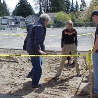 Examining the soil following asphalt removal.