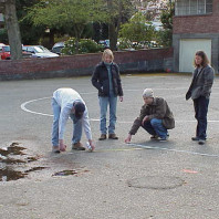 Marking the area where asphalt is to be removed and beds added.