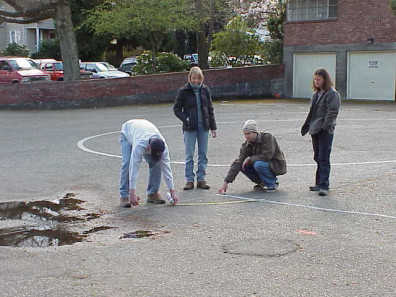 Marking the area where asphalt is to be removed and beds added.