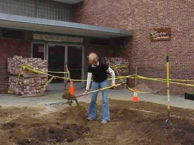 Filling in the big bed with soil and reshaping the planting mounds.