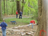 Using woody debris to edge a gravel path and keep mulch off the path.