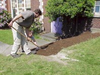 Spreading soil to create a base for the stairs.