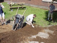 Installing stairs to replace a social path.
