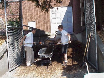 Loading mulch to apply to the site.