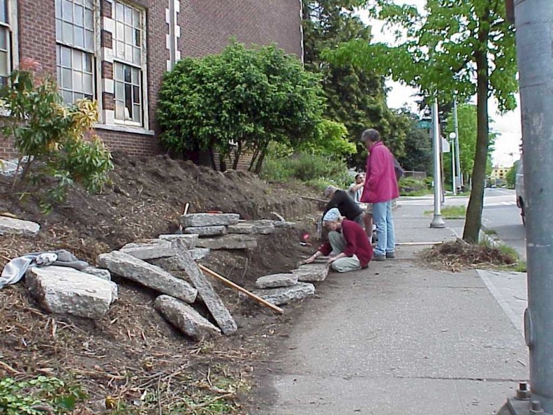 Laying out the concrete pieces for the retaining wall.