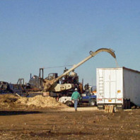 Chipper loading processed chips into a traler for transport.