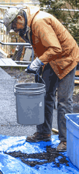Gif photo of dropping bucket to calculate Compost Bulk Density.