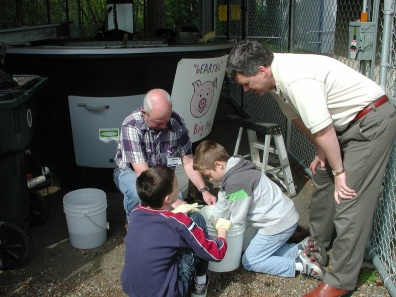 People using Earth Tub Composter