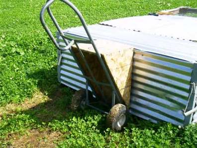 Photo of pasture Poultry Cage, dolly and wedge used to raise rear of cage to move it.