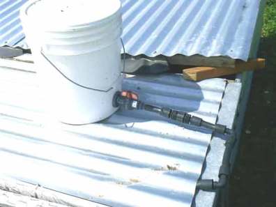 Photo of pasture Poultry Cage, bucket water system on top of cage.