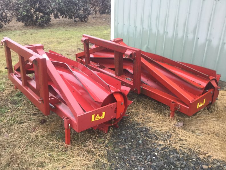 Photo of two Roller/Crimpers, front mounted on tractor to crimp cover crops stems to terminate them while leaving them in place to provide a mulch.
