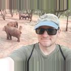 Former graduate student with elephants in the background