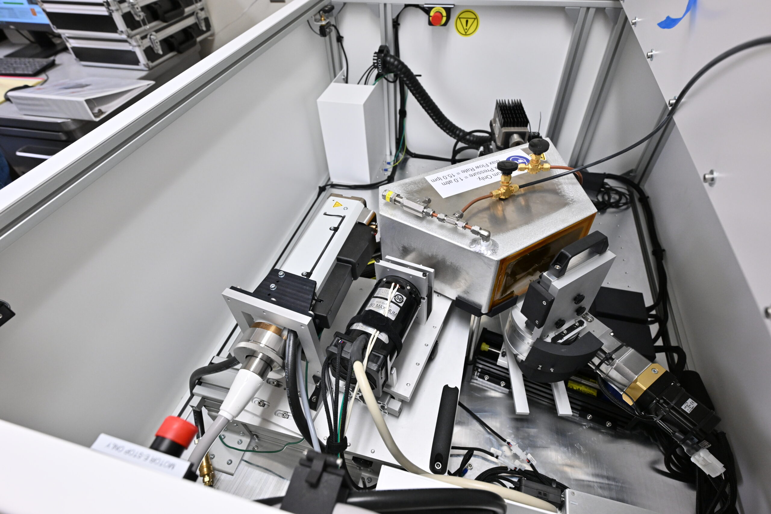 A nuclear reactor glows blue at the bottom of a pool of water.