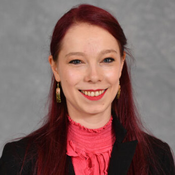 A nuclear reactor glows blue at the bottom of a pool of water.