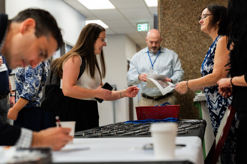 People at the AGI Day registration table