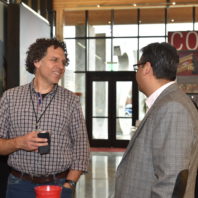 A photo of two men talking at a the Recognition Reception