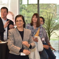 A photo of a group of people clapping at the Recognition Reception