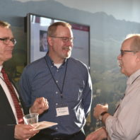 A group photo of three faculty members having a conversation at the Recognition Reception