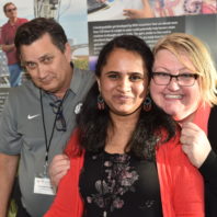 A group photo of three faculty members smiling