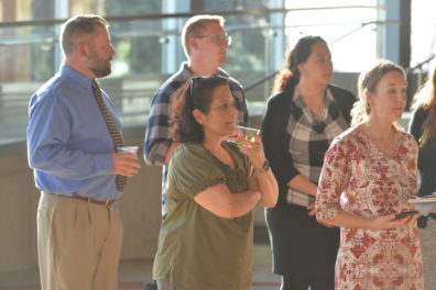 A photo of a group of faculty members watching