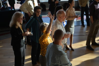 A photo of a group of people watching presentations