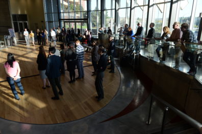 A photo of a group of faculty members watching a presentation