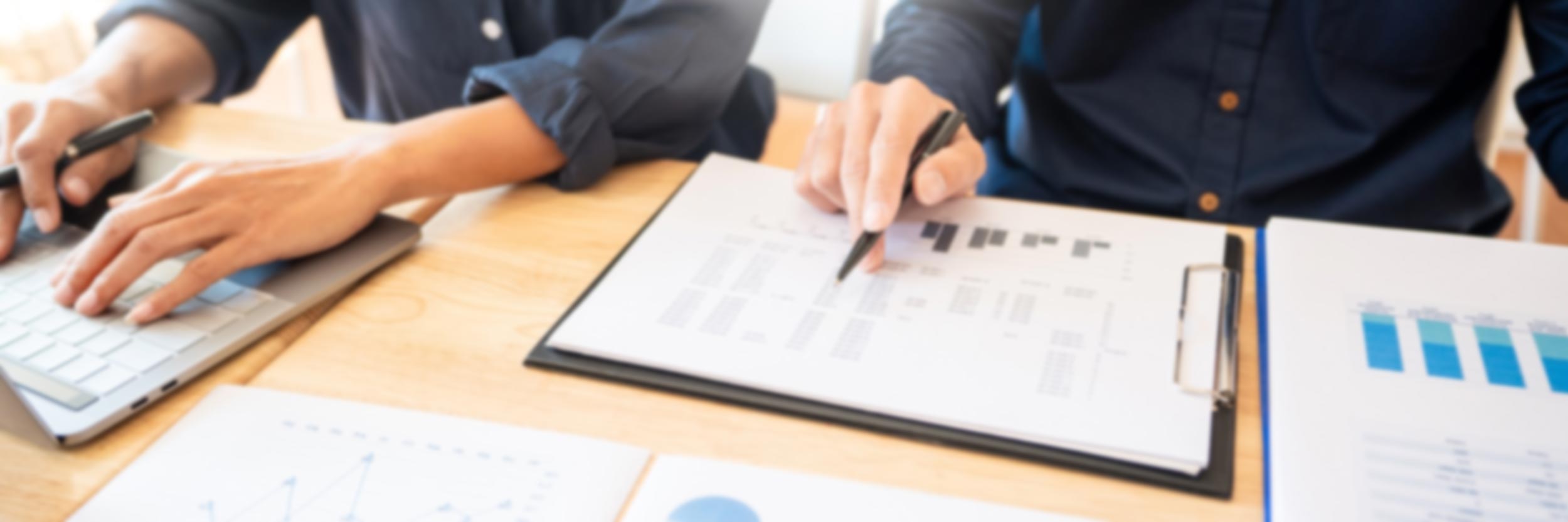 People discussing data a numbers at a meeting.