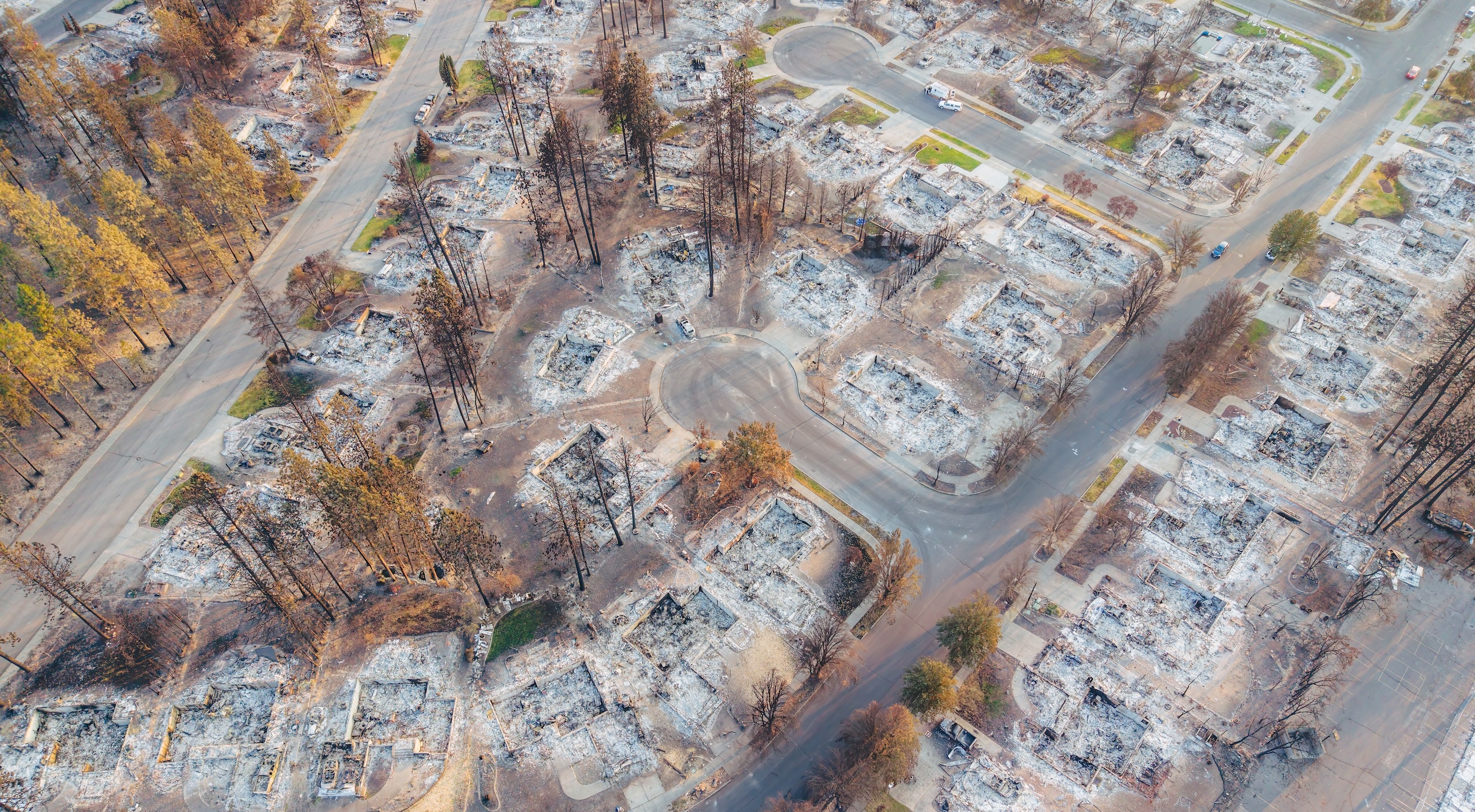 Aerial view of a Spokane, WA, neighborhood leveled by 2026 wildfires.