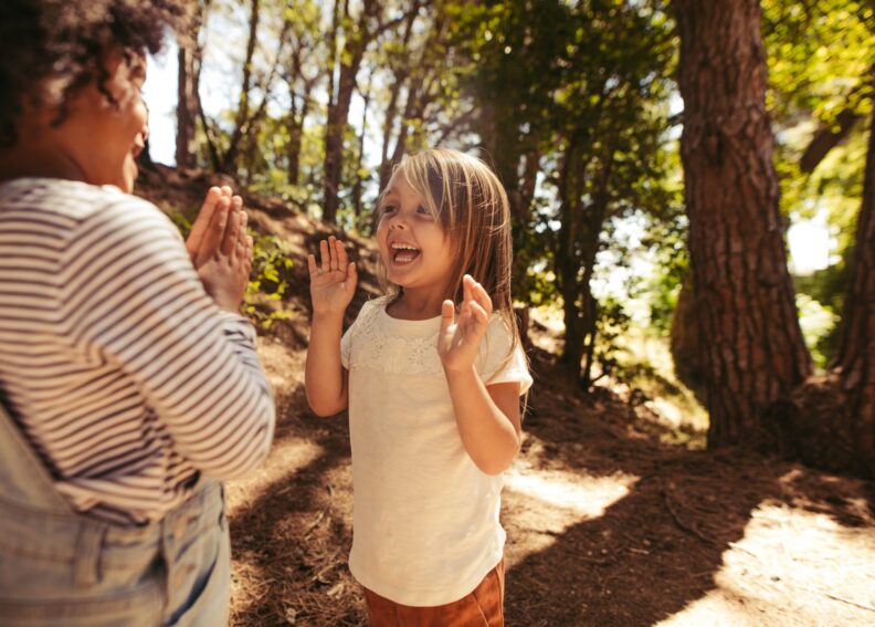Two children playing games together outdoors.