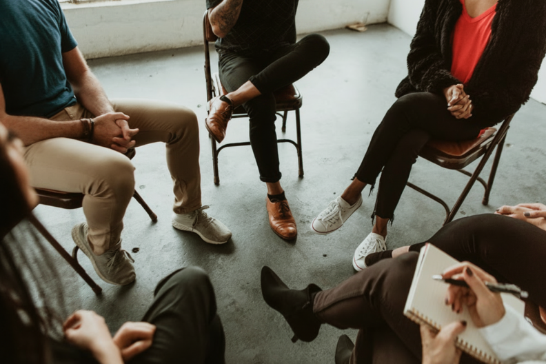 Several people meeting in a support group