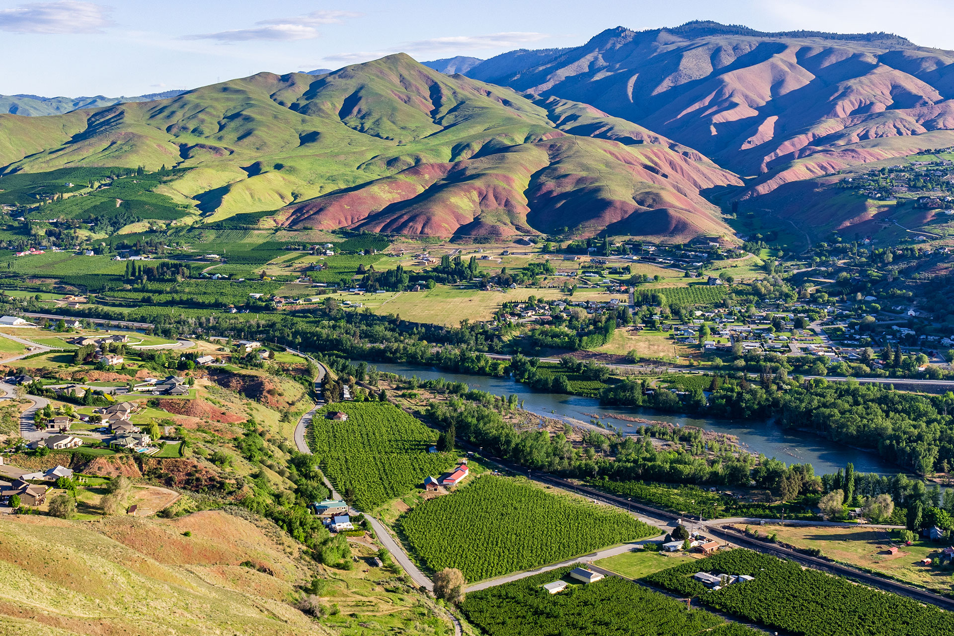 Wenatchee hills with farmland along the river.