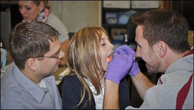 child being checked for strep throat