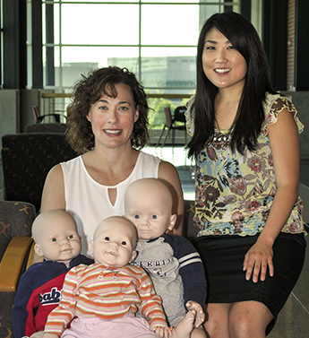 terriff and song pose with dummy babies