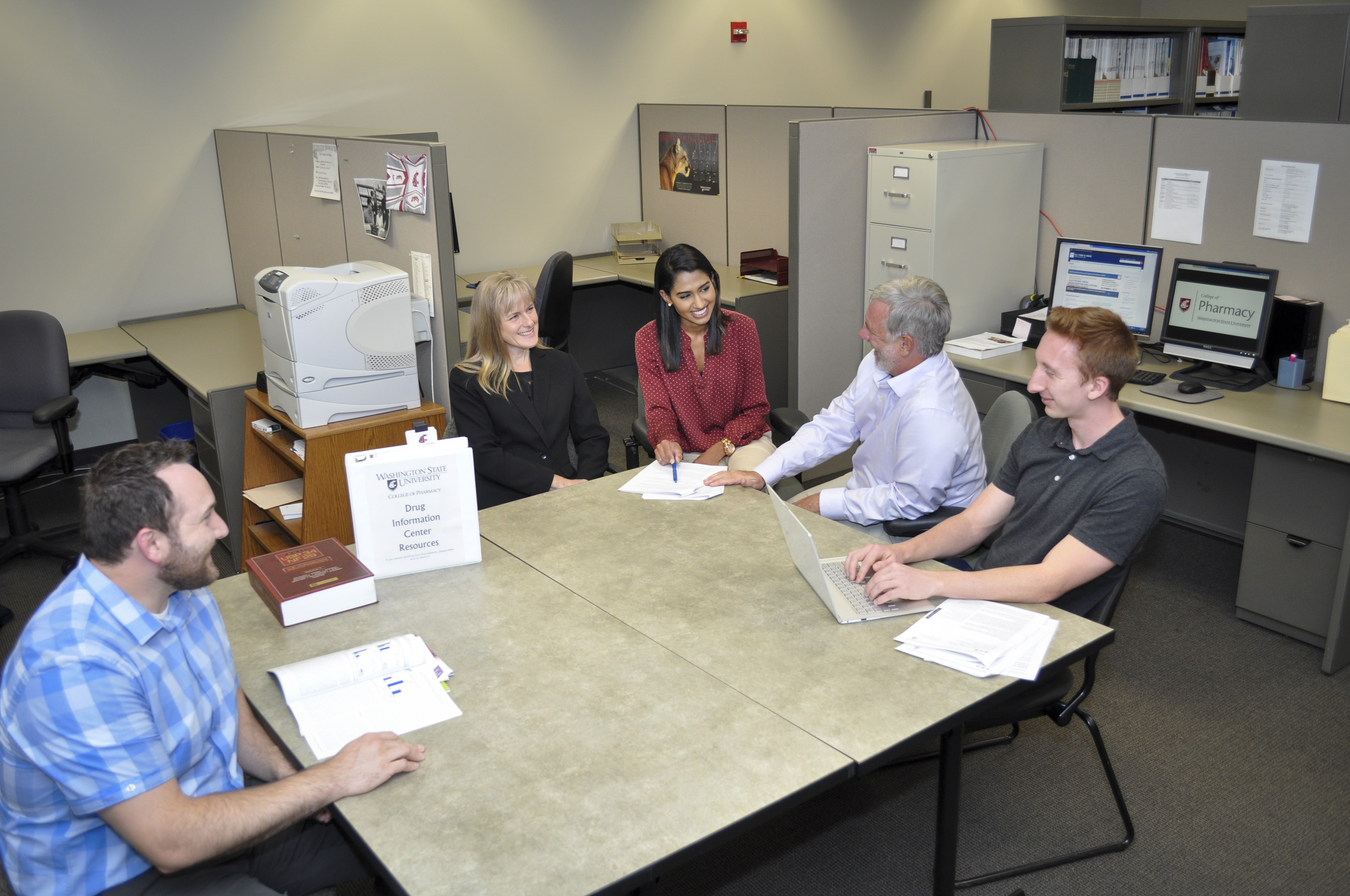 The Drug Information Center Team working together on a drug inquiry.