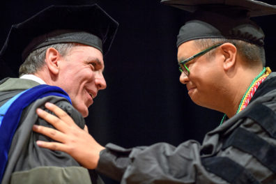 student shakes hands with the dean