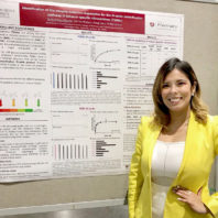 Yadira Pérez-Páramo stands by her research poster