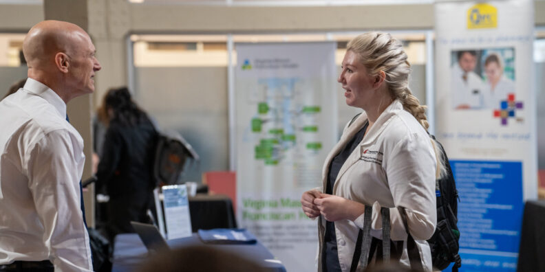 Pharmacy student talks to a recruiter during Career Fair