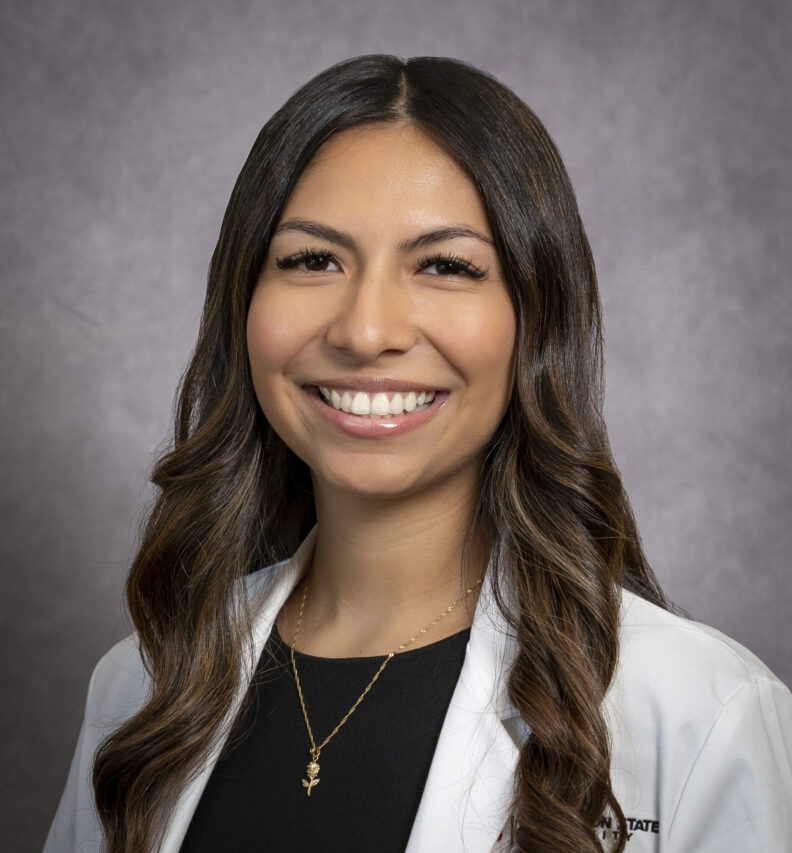 Class of 2027 Doctor of Pharmacy student Karina Jimenez wearing her Washington State University white coat, the traditional coat that pharmacists wear.