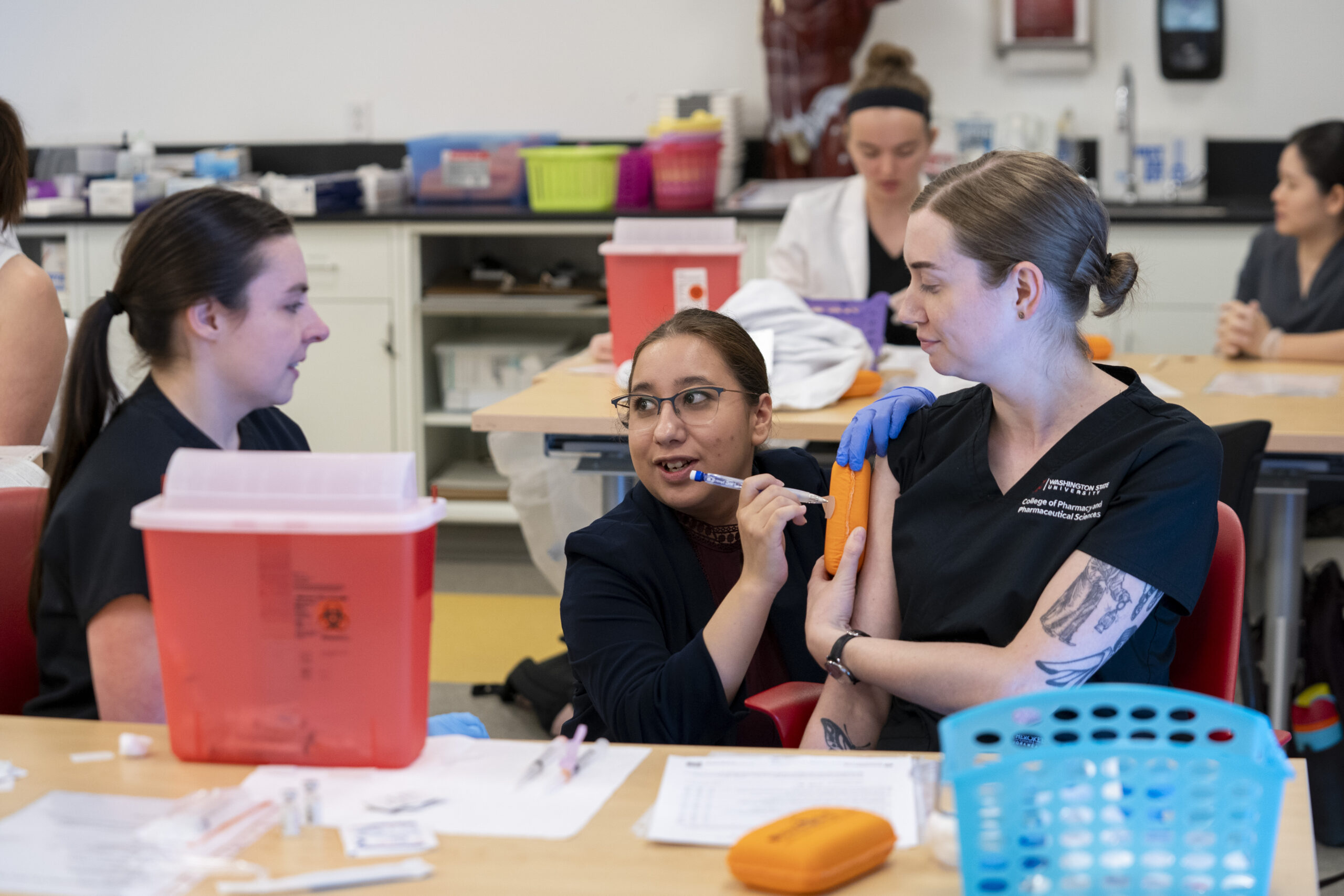 Fred Meyer Resident guides second-year pharmacy students in vaccination technique