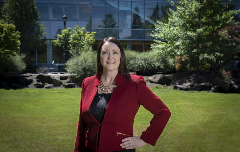 Julie Akers poses in front of the Pharmaceutical and Biomedical Sciences building