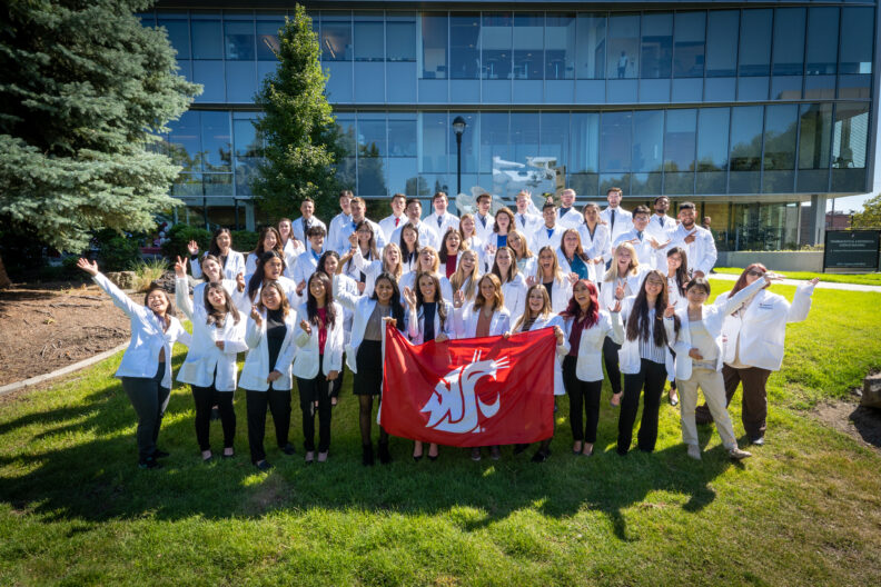 Class of 2026 group photo in their white coats.